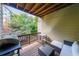 Outdoor balcony features wooden floors, chairs, and grill for a relaxing experience at 991 Sibley Ne Ln, Atlanta, GA 30324