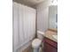 Bathroom featuring a vanity with granite countertop and tiled shower with patterned curtain at 991 Sibley Ne Ln, Atlanta, GA 30324