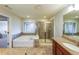 Bathroom featuring a bathtub, glass shower, and granite countertop vanity at 991 Sibley Ne Ln, Atlanta, GA 30324