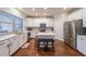 Modern white kitchen with stainless steel appliances and a center island with seating at 991 Sibley Ne Ln, Atlanta, GA 30324
