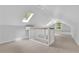 Bright attic with skylights, hardwood floors, and a railing, offering a flexible living space at 115 Ocee View Ct, Alpharetta, GA 30022