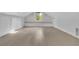 Bright attic with a large window and hardwood floors, complemented by custom-built cabinets at 115 Ocee View Ct, Alpharetta, GA 30022