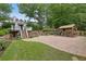 An amazing backyard space featuring an outdoor kitchen, a guest house and a beautiful brick patio at 115 Ocee View Ct, Alpharetta, GA 30022