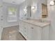 Bright bathroom featuring a double sink vanity with marble countertop and modern lighting at 115 Ocee View Ct, Alpharetta, GA 30022