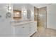Elegant bathroom featuring double vanity, oval mirrors, modern lighting, and glass-enclosed shower at 115 Ocee View Ct, Alpharetta, GA 30022