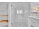 Luxurious bathroom with a glass enclosed shower, white cabinetry, and decorative tiles at 115 Ocee View Ct, Alpharetta, GA 30022