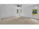 Spacious bedroom features large windows, neutral carpet, and a modern ceiling fan at 115 Ocee View Ct, Alpharetta, GA 30022