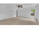 Airy bedroom features neutral carpet, modern ceiling fan, and a large window at 115 Ocee View Ct, Alpharetta, GA 30022