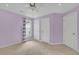 Cozy bedroom with three doors and a large window, providing natural light and closet space at 115 Ocee View Ct, Alpharetta, GA 30022