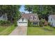 Charming two-story home with a well-manicured lawn, a two car garage, and mature trees at 115 Ocee View Ct, Alpharetta, GA 30022