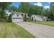 A spacious two-story home with a large driveway, two-car garage, and well-maintained lawn at 115 Ocee View Ct, Alpharetta, GA 30022