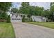 Spacious one-story home with white siding, attached garage, long driveway, and a well-maintained lawn at 115 Ocee View Ct, Alpharetta, GA 30022