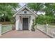 Charming guest house with white railing, a cozy front porch, stylish lighting and a beautiful yard at 115 Ocee View Ct, Alpharetta, GA 30022