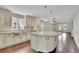 Modern kitchen featuring an island, stainless steel appliances, ample cabinetry, and hardwood floors at 115 Ocee View Ct, Alpharetta, GA 30022