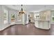 Modern kitchen with stainless appliances, white cabinetry, island, and access to the outdoor patio at 115 Ocee View Ct, Alpharetta, GA 30022