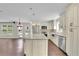 Open kitchen with white cabinets, granite countertops, stainless steel appliances, and a breakfast bar at 115 Ocee View Ct, Alpharetta, GA 30022