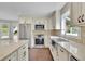 Well-lit kitchen showcasing stainless steel appliances, granite countertops, and a farm-style sink at 115 Ocee View Ct, Alpharetta, GA 30022