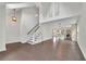 Open-concept living room with hardwood floors, a staircase, high ceilings, and modern light fixtures at 115 Ocee View Ct, Alpharetta, GA 30022