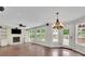 Bright living room features a stone fireplace, built-in shelving, and large windows with backyard views at 115 Ocee View Ct, Alpharetta, GA 30022
