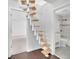 Unique wooden staircase with white supports leads to multiple rooms including an ensuite bathroom at 115 Ocee View Ct, Alpharetta, GA 30022