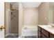 Bathroom featuring walk-in shower, separate bathtub, and modern fixtures at 3313 Thornbridge Dr, Powder Springs, GA 30127