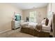 Bright bedroom features a plush bed, neutral walls, and a window view at 3313 Thornbridge Dr, Powder Springs, GA 30127