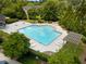 Aerial view of community pool surrounded by lush trees and lounge chairs for relaxing with Gathering and friends at 3313 Thornbridge Dr, Powder Springs, GA 30127