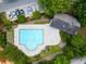 Aerial view of community pool surrounded by lush trees and lounge chairs for relaxing with Gathering and friends at 3313 Thornbridge Dr, Powder Springs, GA 30127