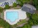 Aerial view of community pool surrounded by lush trees and lounge chairs for relaxing with Gathering and friends at 3313 Thornbridge Dr, Powder Springs, GA 30127