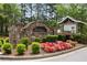 Community entrance with stone sign, lush landscaping, and graduation sign at 3313 Thornbridge Dr, Powder Springs, GA 30127