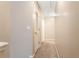 Hallway featuring neutral tones, with multiple doors and a cozy carpet at 3313 Thornbridge Dr, Powder Springs, GA 30127
