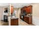 Well-lit kitchen features dark wood cabinets, stainless steel sink, and updated appliances at 3313 Thornbridge Dr, Powder Springs, GA 30127