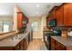 The kitchen is well-lit with wood cabinets, stainless steel appliances, and durable countertops at 3313 Thornbridge Dr, Powder Springs, GA 30127