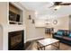 Open concept living room with a fireplace and views into the dining area at 3313 Thornbridge Dr, Powder Springs, GA 30127