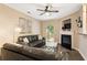 Cozy living room with a fireplace, ceiling fan, and sliding doors to the outside at 3313 Thornbridge Dr, Powder Springs, GA 30127