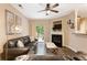 Cozy living room featuring a fireplace, ceiling fan, and sliding doors to the outside at 3313 Thornbridge Dr, Powder Springs, GA 30127