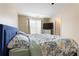 Spacious main bedroom with a blue bed frame, neutral walls, and a window at 3313 Thornbridge Dr, Powder Springs, GA 30127