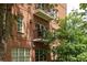 A brick condo building boasts private balconies for each unit, perfect for outdoor relaxation and enjoyment at 351 Washington Ne Ave # 205, Marietta, GA 30060