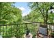 Scenic balcony view with seating amidst lush greenery and clear blue skies at 351 Washington Ne Ave # 205, Marietta, GA 30060