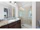 This bathroom has granite counters, and a frameless glass enclosed shower with marble tile at 351 Washington Ne Ave # 205, Marietta, GA 30060