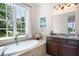 Bright bathroom with a large window, soaking tub and rich dark cabinets at 351 Washington Ne Ave # 205, Marietta, GA 30060