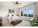 Cozy bedroom with a large window offering scenic views, complemented by a ceiling fan and stylish decor at 351 Washington Ne Ave # 205, Marietta, GA 30060