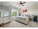 Bright bedroom boasts large window, ceiling fan, neutral walls, and a comfortable king bed at 351 Washington Ne Ave # 205, Marietta, GA 30060