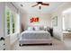 This bedroom features a ceiling fan, neutral walls, large window, king bed and access to a bathroom at 351 Washington Ne Ave # 205, Marietta, GA 30060