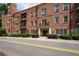 Classic brick building with manicured landscaping and elegant entrance at 351 Washington Ne Ave # 205, Marietta, GA 30060