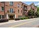 Beautiful brick condo building with arched entryway and manicured bushes at 351 Washington Ne Ave # 205, Marietta, GA 30060