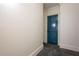 Hallway with a blue door and gray striped carpet leading to an unknown room at 351 Washington Ne Ave # 205, Marietta, GA 30060