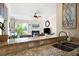 Granite countertop and kitchen sink with the living room and fireplace in the background at 351 Washington Ne Ave # 205, Marietta, GA 30060