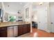 Gourmet kitchen with a view of the living room, featuring stainless steel appliances and wood flooring at 351 Washington Ne Ave # 205, Marietta, GA 30060