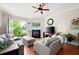 Spacious living room with a fireplace, balcony, hardwood floors, and ample seating at 351 Washington Ne Ave # 205, Marietta, GA 30060